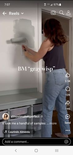 a woman standing in front of a white refrigerator