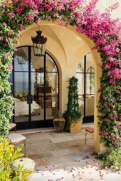 an archway with pink flowers on it