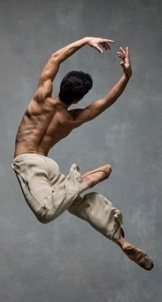 a shirtless male dancer in the air