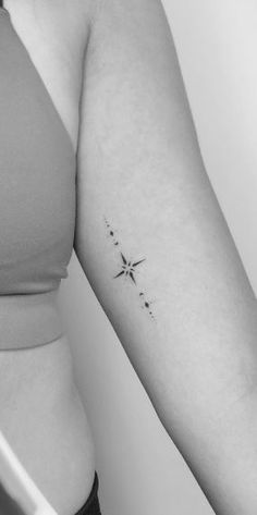 a woman with a star tattoo on her arm