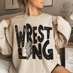 Wrestling Sweatshirt Crewnecks Hoodies Crewneck Sweatshirt sports Support Wrestling Shirts School Spirit Shirts Wrestling T-Shirt Game Day Tshirt High School College Team Pride Wrestling Mom Dad Nana Aunt Match Tee PLEASE NOTE: These sweatshirts are unisex and fit true to size! If you prefer an oversized fit, be sure to size up 1-2 sizes! For a VERY OVERSIZED fit, size up 2+ sizes. There is a size chart in the listing photos which has the measurements for you to be able to pick the perfect size My Heart Is On The Mat Wrestling Shirt, Mat Maid Shirts Wrestling, Middle School Wrestling Shirts, Wrestling Sweatshirts, Wrestling Attire, Spirit Pants, Wrestling Mom Shirts, Wrestling Shirt, Coach Shirt