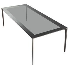 a glass table with metal legs and a black top on an isolated white background,