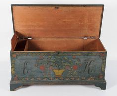 an old wooden box with floral designs on it