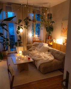 a living room filled with furniture and candles