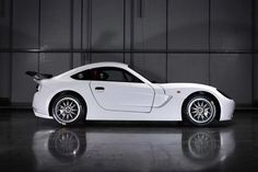 a white sports car parked in a garage