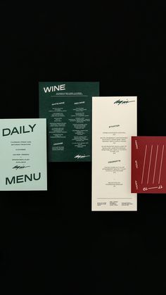 three different types of wine menus on a black background with red and white paper