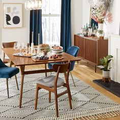 a dining room table with blue chairs around it