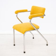 a yellow chair sitting on top of a white floor