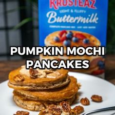 pumpkin mochi pancakes with blueberries and pecans on a plate next to a bag of buttermilk