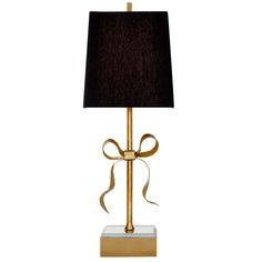 a gold lamp with a black shade on the base and a brown ribbon tied around it