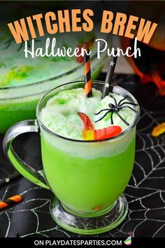 witches brew halloween punch in a green mug with candy on the rim and spider legs