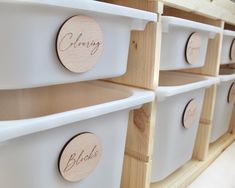 several white bins with wooden labels on them