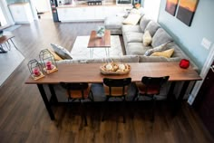 a living room filled with furniture and a wooden table