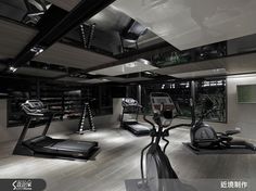 a gym with treads, exercise machines and other equipment in the room at night