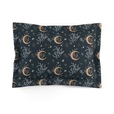 a pillow case with an image of the moon and stars on it, in black