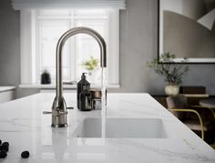 a kitchen with marble counter tops and white cabinets, along with blackberries on the floor