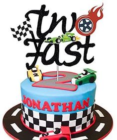 a birthday cake with cars on it and the words, two fast written in black