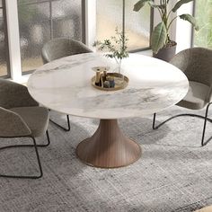 a white marble dining table surrounded by grey chairs