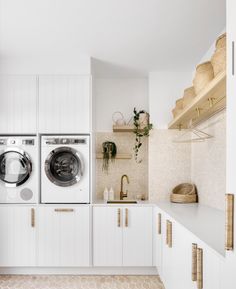 a washer and dryer in a white laundry room with honeycomb flooring