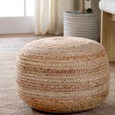 a large round woven ottoman on the floor