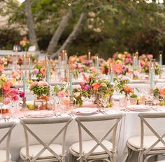 a long table is set with flowers and candles