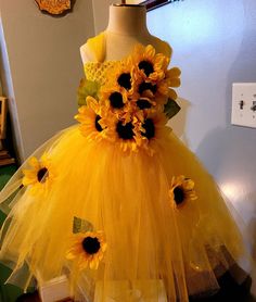 a dress made out of tulle with sunflowers on it