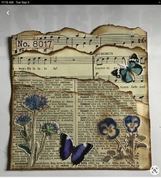 altered photograph of butterflies and flowers on an old book page with sheet music notes in the background