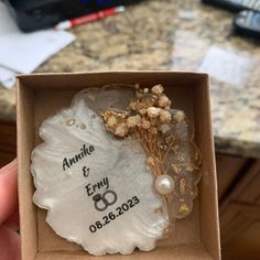 a wedding ring in a box with flowers and pearls on the inside that says annke & ery