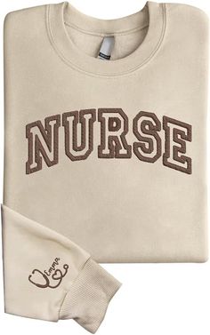 a white shirt with the word nurse printed on it and a pair of gloves next to it