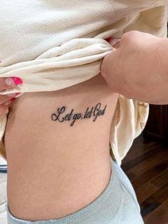 a woman with a tattoo that says let go tell you