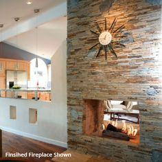 a clock mounted to the side of a stone wall in a living room next to a fireplace