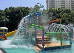 the water park is full of colorful slides and playsets for children to play in