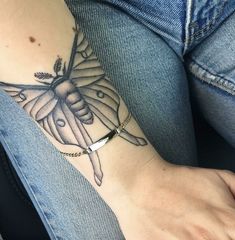 a woman's arm with a butterfly tattoo on the left side of her arm