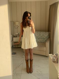 Non Country Cowboy Boot Outfit, Straw Hat And Dress Outfit, Sundress Cowgirl Boots, White Flowy Dress With Cowgirl Boots, Cute Stagecoach Outfits, Sundress Cowboy Boots Summer Outfits, Women’s Western Boots Outfits, Taylor Swift White Dress Cowboy Boots, Skirt As A Top Outfit