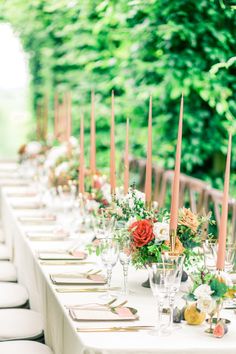 a long table with candles and flowers on it