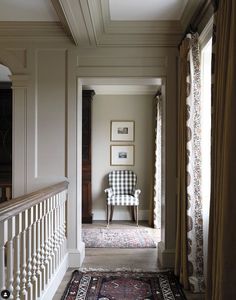 a chair sitting on top of a rug next to a window