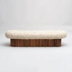 a bench made out of wood and sheep's wool is shown in front of a white background