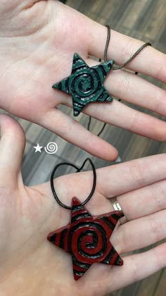 two handmade ornaments in the palm of someone's hand, one red and one green