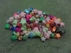 a pile of colorful bows laying on top of a green blanket