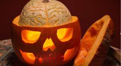 a pumpkin carved to look like a human skull with its head cut out and glowing inside