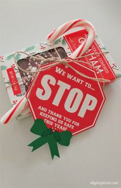 a red stop sign sitting on top of a white table next to candy canes