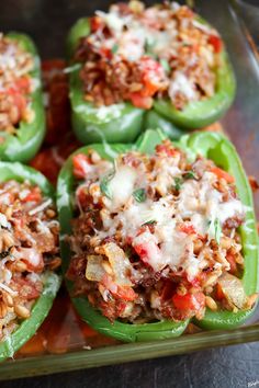 green peppers stuffed with rice and meat in a baking dish