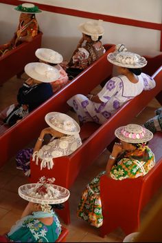 several people sitting in rows with hats on their heads