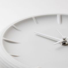 a close up of a white clock face