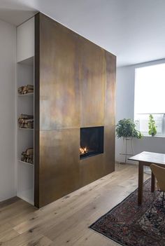 a living room filled with furniture and a fire place next to a wall mounted fireplace