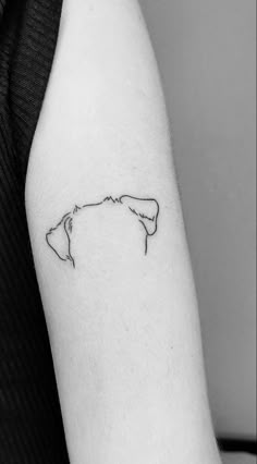 a black and white photo of a woman's arm with a small outline of the state of michigan