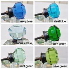 four different colors of glass knobs with names