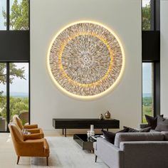 a living room filled with furniture and a large circular artwork