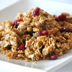 granola on a white plate with cranberries and nuts