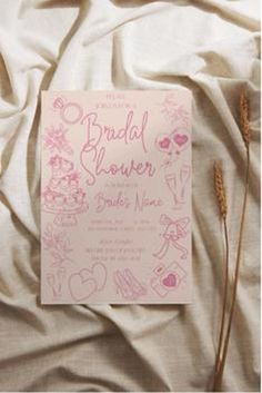 a card with the words bridal shower written on it next to some dried flowers